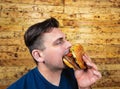 Happy man with his fast food burger. Not so much healthy life style, but whatever Royalty Free Stock Photo