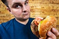 Happy man with his fast food burger. Not so much healthy life style, but whatever Royalty Free Stock Photo