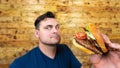 Happy man with his fast food burger. Not so much healthy life style, but whatever Royalty Free Stock Photo