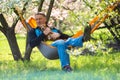 Happy man with his funny dog dachshund relaxes in a hammock Royalty Free Stock Photo