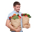 Happy man hold bags with healthy food, grocery buyer isolated Royalty Free Stock Photo