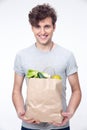 Happy man holding a bag full of groceries Royalty Free Stock Photo