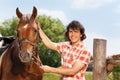 Happy man holding his beautiful horse by a bridle Royalty Free Stock Photo