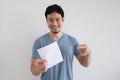 Happy man is holding an invoice letter on isolated white background.