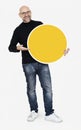 Happy man holding round yellow board