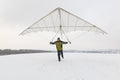 Happy man holds vintage hang glider wing