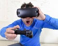 Happy man at home living room sofa couch excited using 3d goggles watching 360 virtual reality