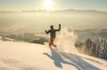 Happy Man with hood running in deep powder snow with snowshoes at sunrise. Snow is spraying and splashing. Allgau Alps Royalty Free Stock Photo