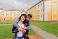 Happy man hugs a woman in the street