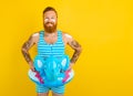 Happy man with inflatable donut with elephant is ready to swim Royalty Free Stock Photo