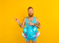 Happy man with inflatable donut with elephant is ready to swim Royalty Free Stock Photo