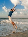 Happy man jump near sea