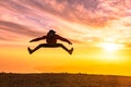 Happy man jumping for joy at sunset. Success, winner, happiness, ttavel concept Royalty Free Stock Photo