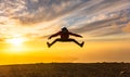 Happy man jumping for joy at sunset. Success, winner, happiness, ttavel concept Royalty Free Stock Photo