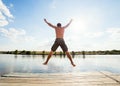 Happy man jumping on pier Royalty Free Stock Photo