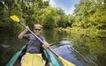 Happy Man Kayaking down beautiful jungle river