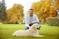 Happy man with labrador dog in autumn city park Royalty Free Stock Photo