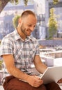 Happy man with laptop outdoors Royalty Free Stock Photo