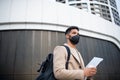 Happy man with laptop on the way to work outdoors in city, coronavirus concept. Royalty Free Stock Photo