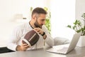 Happy man with laptop after winning his sports bet at home Royalty Free Stock Photo