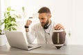 Happy man with laptop after winning his sports bet at home Royalty Free Stock Photo