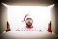 Surprised man unpack Christmas gift box Royalty Free Stock Photo