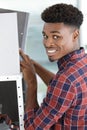 Happy man looking for folder on shelf Royalty Free Stock Photo