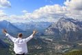 Happy man looking at a panorama of a small town Banff in a Bow river valley Royalty Free Stock Photo