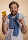 Happy man looking smartphone display rejoicing win, celebrating, receiving money dollar cash jackpot