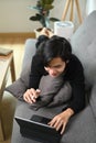 Man lying on comfortable sofa and using computer tablet. Royalty Free Stock Photo