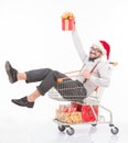 Happy man lying in shopping cart