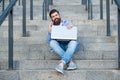 Happy man making mobile call relaxing on stairs outdoors. Smiling man talking on mobile phone Royalty Free Stock Photo