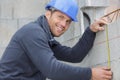 happy man measuring wall Royalty Free Stock Photo