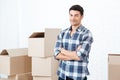 Happy man moving in carrying carton boxes Royalty Free Stock Photo