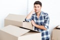 Happy man moving in and carrying carton boxes Royalty Free Stock Photo