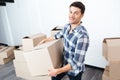 Happy man moving in and carrying carton boxes Royalty Free Stock Photo