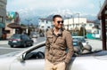 Happy man near cabriolet car over city in japan Royalty Free Stock Photo
