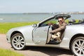 Happy man opening door of cabriolet car outdoors Royalty Free Stock Photo