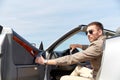 Happy man opening door of cabriolet car outdoors Royalty Free Stock Photo