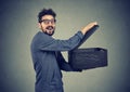 Happy man opening storage box and sharing its contents Royalty Free Stock Photo