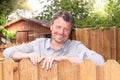 Happy man outdoor handsome smiling middle aged guy in home garden with wood hut Royalty Free Stock Photo