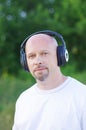 Happy man outdoors in wireless headset Royalty Free Stock Photo