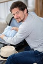 happy man packing clothes into travel bag Royalty Free Stock Photo