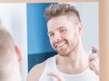 Happy man perfuming himself Royalty Free Stock Photo
