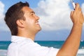 Happy man with phone on the beach Royalty Free Stock Photo