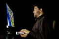 Happy man playing videogame on desktop computer