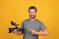 happy man point finger on camcorder. videographer making video. movie maker make vlog