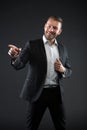 Happy man point finger on dark background. Bearded man smile in formal suit. Businessman with beard and hairstyle