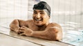 Happy, man and portrait of athlete in swimming pool after training, workout or exercise for wellness and cardio fitness Royalty Free Stock Photo