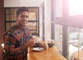 Happy man, portrait and cafe with coffee by window for morning, breakfast or start of the day. Male person with smile Royalty Free Stock Photo